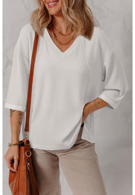 White solid color corded fabric
  V
  neck design
  Drop shoulder
  3/4 sleeves with folded cuffs
  Relaxed fit
  Versatile solid color for easy mixing and matching
Material: 75% Polyester 20% Viscose 5% Elastane