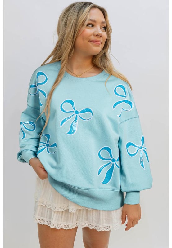 Sudadera de cuello redondo  
  Impresionante detalle de lazo con lentejuelas  
  Diseño moderno con hombros caídos  
  Silueta relajada y elegante  
  Corte oversize para una vibra acogedora pero a la moda  
  Combina bien con diversas prendas inferiores y accesorios  
Material: 65% Poliéster 35% Algodón