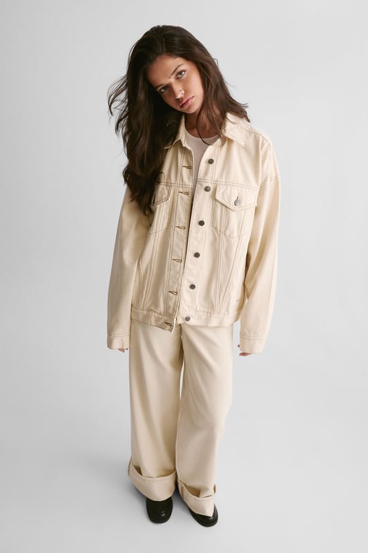 Boxy, oversized fit for a relaxed and trendy silhouette
        Classic denim construction with sturdy button-up front
        Functional chest pockets for added utility and style
        Versatile design suitable for layering over various outfits
        Timeless collar detail for a polished finish
    
    The Oversized Denim Jacket from NastyGal is a wardrobe essential that effortlessly combines comfort with style. This boxy-fit jacket offers a contemporary twist on a classic design, perfect for those seeking a relaxed yet fashionable look. The versatile nature of this piece allows for endless styling possibilities, making it a go-to choice for casual outings and laid-back events. Pair it with wide-leg trousers and chunky trainers for a trendy daytime ensemble, or throw it over a midi dress for a chic contrast at family gatherings. The jacket's roomy silhouette makes it ideal for layering over jumpers during cooler months, while its timeless appeal ensures it will remain a staple in your wardrobe for seasons to come. Whether you're heading to a casual brunch or a relaxed evening with friends, this NastyGal denim jacket will add an effortless cool to any outfit.