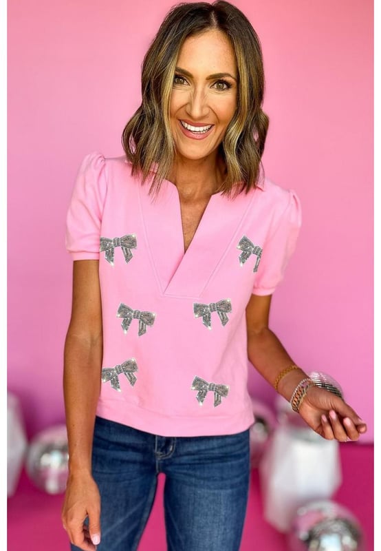 Pink Sequin Bow Knot Patched Collared V Neck T Shirt
  Glitter bowknot design
  Split neckline with collar design
  Short puff sleeves
  Sweet pink color
  Casual style
  Available in sizes S M L and XL
  Size chart available (in CM and INCH)
  Pair with flared jeans or flowy skirts
  Latest designs of graphic tees by  available
Material: 75% Polyester 20% Cotton 5% Elastane
