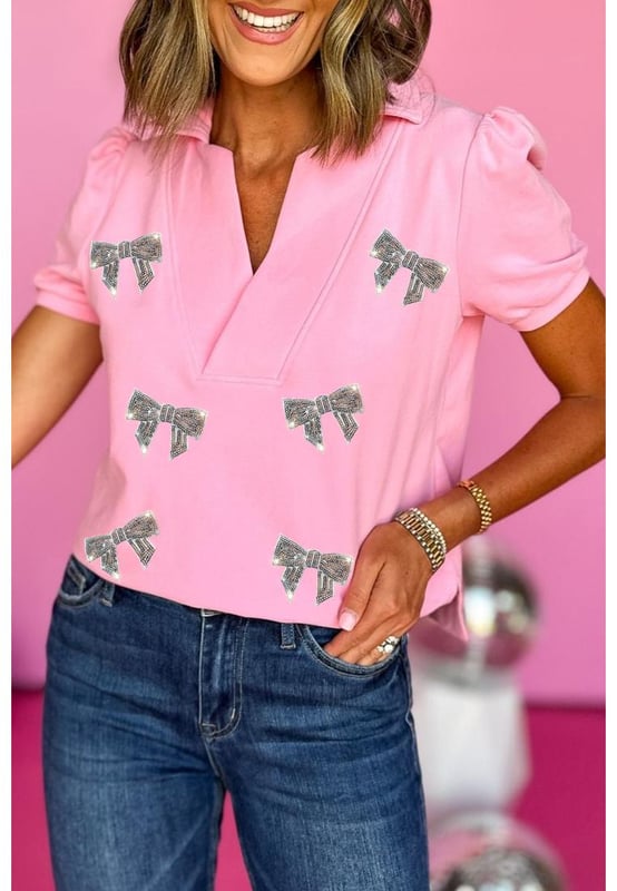 Pink Sequin Bow Knot Patched Collared V Neck T Shirt
  Glitter bowknot design
  Split neckline with collar design
  Short puff sleeves
  Sweet pink color
  Casual style
  Available in sizes S M L and XL
  Size chart available (in CM and INCH)
  Pair with flared jeans or flowy skirts
  Latest designs of graphic tees by  available
Material: 75% Polyester 20% Cotton 5% Elastane