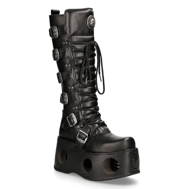 New Rock M-272-S2 Neptuno Metallic Knee High Black Leather Gothic Boots The New Rock M-272-S2 Neptuno boots from the Metallic Collection redefine gothic and punk-rock style with their towering design. Crafted from premium black cow leather with a pigskin interior, they offer durability and comfort. The extra-high 38 cm shaft, bold buckles, and signature logo on the tongue add to their fierce aesthetic. Featuring an impressive 11 cm platform heel with distinctive cutouts, these boots are a statement piece for those who embrace alternative fashion.
Key Features:
Material: Outer - Cow Leather | Inner - Pigskin
Heel Height: 11 cm | Platform Height: 9 cm
Sole Material: TPU | Fixing System: Glued
Fastening: Laces & Buckles
Shaft Height: 38 cm
Style: Gothic, Heavy, Punk, Rock
Unisex Design: Suitable for all gernders
Distinctive Details: Buckled shaft, perforated platform, logo on tongue