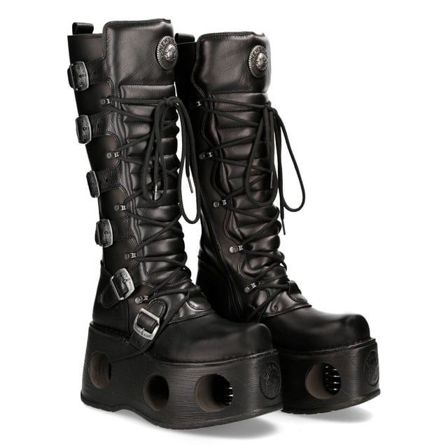 New Rock M-272-S2 Neptuno Metallic Knee High Black Leather Gothic Boots The New Rock M-272-S2 Neptuno boots from the Metallic Collection redefine gothic and punk-rock style with their towering design. Crafted from premium black cow leather with a pigskin interior, they offer durability and comfort. The extra-high 38 cm shaft, bold buckles, and signature logo on the tongue add to their fierce aesthetic. Featuring an impressive 11 cm platform heel with distinctive cutouts, these boots are a statement piece for those who embrace alternative fashion.
Key Features:
Material: Outer - Cow Leather | Inner - Pigskin
Heel Height: 11 cm | Platform Height: 9 cm
Sole Material: TPU | Fixing System: Glued
Fastening: Laces & Buckles
Shaft Height: 38 cm
Style: Gothic, Heavy, Punk, Rock
Unisex Design: Suitable for all gernders
Distinctive Details: Buckled shaft, perforated platform, logo on tongue