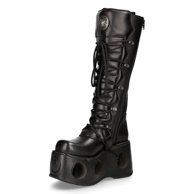 New Rock M-272-S2 Neptuno Metallic Knee High Black Leather Gothic Boots The New Rock M-272-S2 Neptuno boots from the Metallic Collection redefine gothic and punk-rock style with their towering design. Crafted from premium black cow leather with a pigskin interior, they offer durability and comfort. The extra-high 38 cm shaft, bold buckles, and signature logo on the tongue add to their fierce aesthetic. Featuring an impressive 11 cm platform heel with distinctive cutouts, these boots are a statement piece for those who embrace alternative fashion.
Key Features:
Material: Outer - Cow Leather | Inner - Pigskin
Heel Height: 11 cm | Platform Height: 9 cm
Sole Material: TPU | Fixing System: Glued
Fastening: Laces & Buckles
Shaft Height: 38 cm
Style: Gothic, Heavy, Punk, Rock
Unisex Design: Suitable for all gernders
Distinctive Details: Buckled shaft, perforated platform, logo on tongue