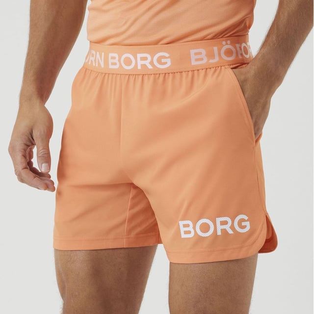 Björn Borg - Men’s Technical Training Shorts: Stay confident when training in these sleek Men's Technical Shorter-Length Training Shorts by Björn Borg. They are great for everyday use and any type of training you might be doing. The Björn Borg Short Shorts are sleek and technical training shorts made from 92% recycled polyester stretch quality fabric with jersey fabric between the legs. They are constructed with a breathable material that dries quickly. They are regular fit with a short leg length, and feature a branded elastic around the waist for easy adjustment and support. With front pockets and slits on the side for extra movement. The shorts feature an iconic Borg logo on the side. The recycled material makes them perfect for hot weather, keeping you cool while you're sweating. It’s not only high quality but Eco Friendly as well, so you can feel good about what you're wearing and doing for the environment!. These shorts are made from: 92% Polyester (Recycled), 8% Elastane and come in 4 sizes: Small, Medium, Large & X-Large. They come in 2 colours: Black or Cadmium Orange and are Machine Washable. Extra Product Details: Björn Borg Men’s Shorts Ideal For Everyday Great For Workouts & Training Breathable Material Jersey Fabric Between Legs Branded Elasticated Waist Iconic Borg Logo On Side Quick Drying Comes In Black or Orange 92% Recycled Polyester Eco Friendly