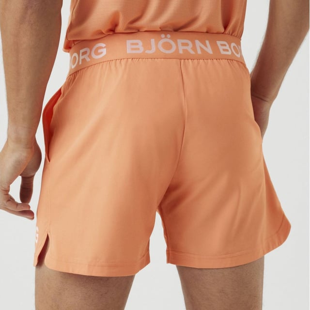 Björn Borg - Men’s Technical Training Shorts: Stay confident when training in these sleek Men's Technical Shorter-Length Training Shorts by Björn Borg. They are great for everyday use and any type of training you might be doing. The Björn Borg Short Shorts are sleek and technical training shorts made from 92% recycled polyester stretch quality fabric with jersey fabric between the legs. They are constructed with a breathable material that dries quickly. They are regular fit with a short leg length, and feature a branded elastic around the waist for easy adjustment and support. With front pockets and slits on the side for extra movement. The shorts feature an iconic Borg logo on the side. The recycled material makes them perfect for hot weather, keeping you cool while you're sweating. It’s not only high quality but Eco Friendly as well, so you can feel good about what you're wearing and doing for the environment!. These shorts are made from: 92% Polyester (Recycled), 8% Elastane and come in 4 sizes: Small, Medium, Large & X-Large. They come in 2 colours: Black or Cadmium Orange and are Machine Washable. Extra Product Details: Björn Borg Men’s Shorts Ideal For Everyday Great For Workouts & Training Breathable Material Jersey Fabric Between Legs Branded Elasticated Waist Iconic Borg Logo On Side Quick Drying Comes In Black or Orange 92% Recycled Polyester Eco Friendly