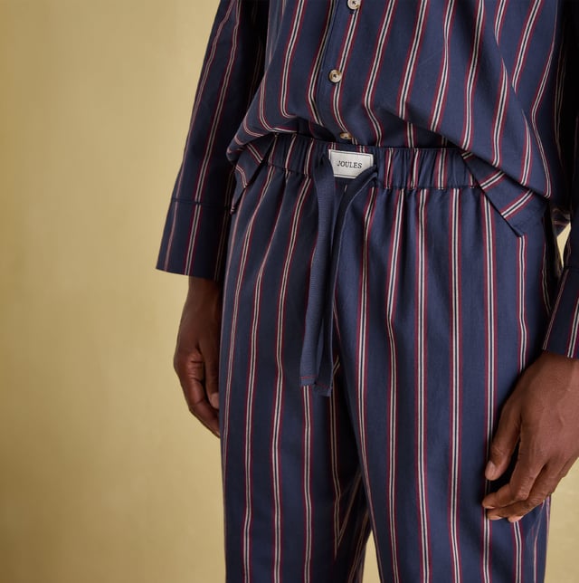 Joules Joules HUGO Mens Pyjama Set Navy Stripe

Closure/Fastening: Button,Pull-On

Features: Comfort

Item Weight: 0.4 KG

Clothing Fit: Regular

Single Or Multi Pack?: Single

Gift Boxed: No

Material Composition: 100% Cotton

Clothing Features: Single Chest Pocket | Piped Trims | Elasticated Waist | Drawstring Ties | Branded Tab on Waistband
Product Code: 372828-NVYSTRP