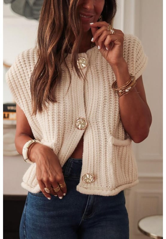 White solid textured knit sweater vest
  Buttoned front closure for a classic look
  Sleeveless design for easy layering
  Side pockets for practical functionality
Material: 100% Acrylic