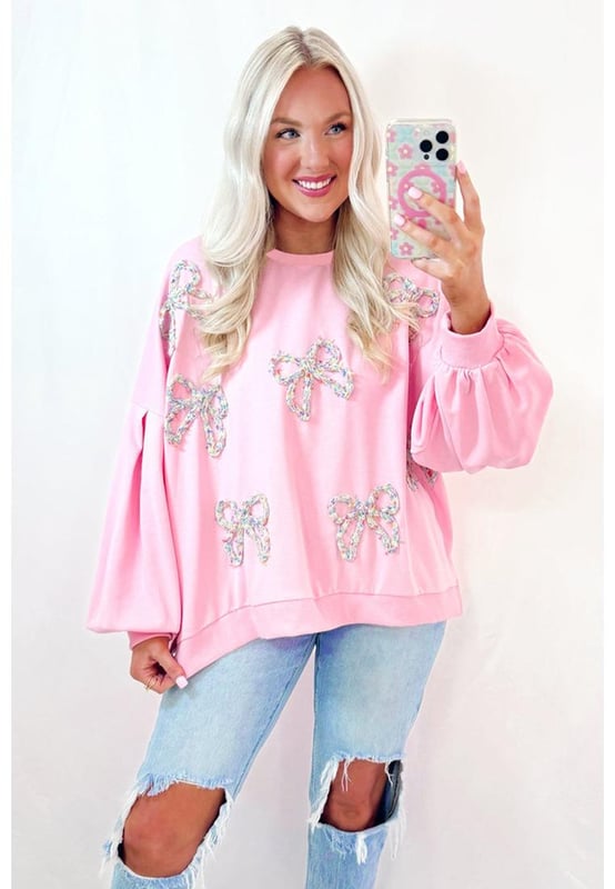 Fashionable pullover sweatshirt for casual wear
  Light pink color with embroidered bows for a feminine flair
  Lantern sleeves and oversized fit for a voluminous look
  Can be paired with jeans or denim shorts
  Ideal for everyday wear
Material: 65% Polyester 35% Cotton