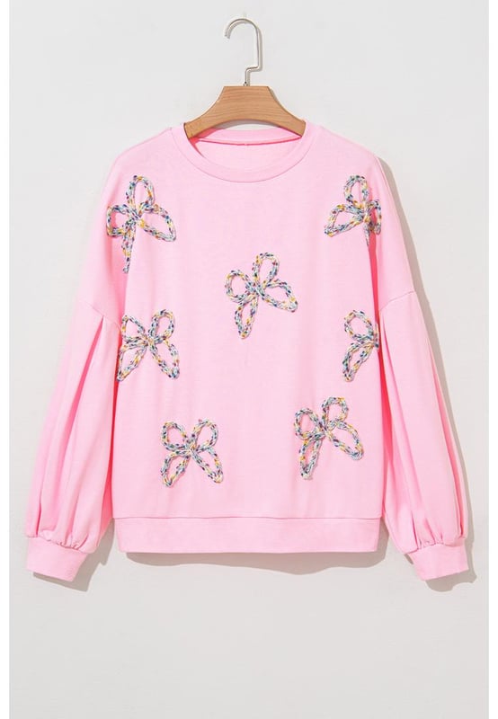 Fashionable pullover sweatshirt for casual wear
  Light pink color with embroidered bows for a feminine flair
  Lantern sleeves and oversized fit for a voluminous look
  Can be paired with jeans or denim shorts
  Ideal for everyday wear
Material: 65% Polyester 35% Cotton