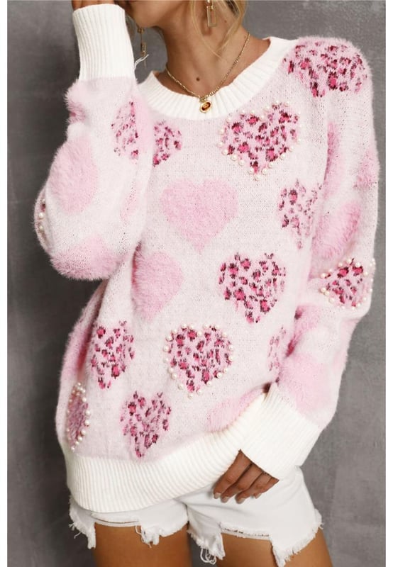 Corazón romántico con forma de corazón y estampado de leopardo  
Detalles perlados para un brillo adicional  
Diseño con ribetes para mayor estructura  
Material suave y acogedor para calidez  
Alta elasticidad