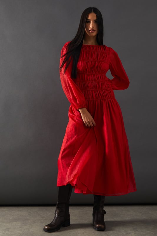 Intricate shirred bodice for a flattering fit
        Chiffon panel detailing adds texture and interest
        Elegant midi length for versatile styling
        Long sleeves with subtle volume for a romantic touch
        Slash neckline offers a sophisticated silhouette
    
    This Warehouse midi dress radiates confidence with its striking shirred bodice and chiffon panel detailing. The elegant slash neckline and long sleeves with a hint of volume create a romantic silhouette perfect for various occasions. Style this versatile piece with strappy heels and statement earrings for a wedding or formal event. For a more relaxed look, pair it with ankle boots and a leather jacket. The midi length allows for easy transition from day to night, making it an ideal choice for those who desire a dress that can adapt to different settings. Whether you're attending a graduation ceremony or heading to the races, this dress will ensure you stand out with its blend of edgy design and feminine charm.