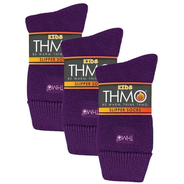 THMO Kids Thermal Slipper Socks: Welcome to the warm embrace of THMO Kids Thermal Slipper Socks, the ultimate choice for keeping your little ones' feet snug and cosy while they embark on their indoor adventures. Designed with a stretchy comfort top that molds to their leg, these socks ensure a snug fit without the worry of constricting rings, promoting good circulation and all-day comfort. Equipped with a cushioned footbed, they offer an extra layer of support for those tiny, bustling feet. But the cosiness doesn't stop there! Double brushed on the inside, these socks are a fortress against the cold, trapping warm air close to the skin and keeping their feet and legs wonderfully warm. Available in a range of colours including Black, Navy, Fuchsia, and Purple, and offered in three kid-friendly sizes, these socks are adorned with the iconic THMO badge, showcasing their quality and style. Made from a blend of 93% Acrylic, 6% Polyamide, and 1% Elastane, they are designed for comfort, warmth, and style. Plus, they're machine washable at 40 degrees, making them as practical as they are adorable. Essential Product Details: - Stretchy and Comfortable - Double Brushed for Maximum Warmth - Anti-Slip Grippers for Safe Play - Available in 4 Vibrant Colours - 3 Kid-Friendly Sizes - Made from a Warm and Durable Blend - Machine Washable for Easy Care