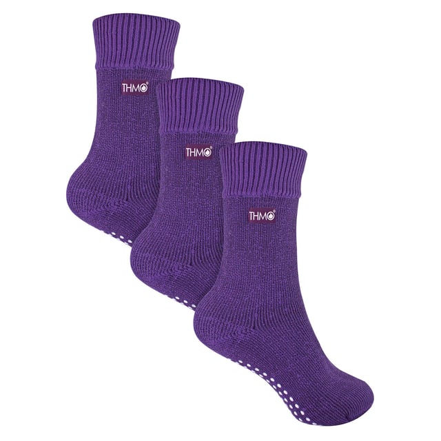 THMO Kids Thermal Slipper Socks: Welcome to the warm embrace of THMO Kids Thermal Slipper Socks, the ultimate choice for keeping your little ones' feet snug and cosy while they embark on their indoor adventures. Designed with a stretchy comfort top that molds to their leg, these socks ensure a snug fit without the worry of constricting rings, promoting good circulation and all-day comfort. Equipped with a cushioned footbed, they offer an extra layer of support for those tiny, bustling feet. But the cosiness doesn't stop there! Double brushed on the inside, these socks are a fortress against the cold, trapping warm air close to the skin and keeping their feet and legs wonderfully warm. Available in a range of colours including Black, Navy, Fuchsia, and Purple, and offered in three kid-friendly sizes, these socks are adorned with the iconic THMO badge, showcasing their quality and style. Made from a blend of 93% Acrylic, 6% Polyamide, and 1% Elastane, they are designed for comfort, warmth, and style. Plus, they're machine washable at 40 degrees, making them as practical as they are adorable. Essential Product Details: - Stretchy and Comfortable - Double Brushed for Maximum Warmth - Anti-Slip Grippers for Safe Play - Available in 4 Vibrant Colours - 3 Kid-Friendly Sizes - Made from a Warm and Durable Blend - Machine Washable for Easy Care