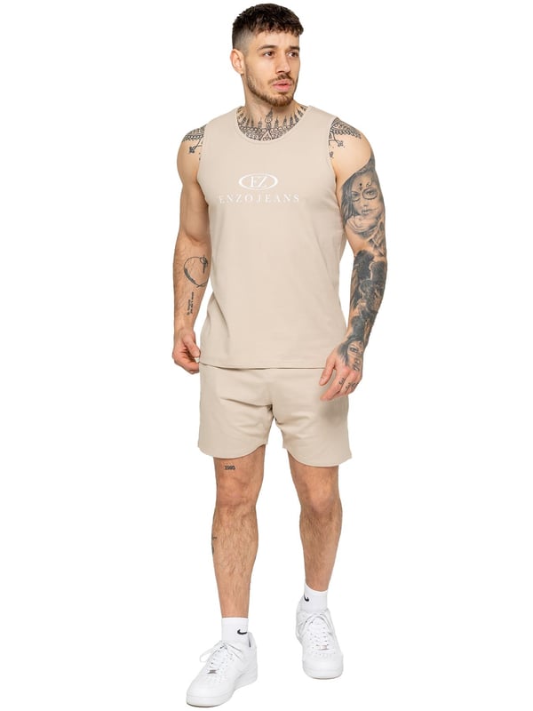 The Enzo Men's Gym Vest & Shorts Tracksuit is designed for ultimate comfort and performance. The regular-fit sleeveless vest provides a relaxed yet athletic look, with stretch material and Lycra fabric ensuring flexibility and freedom of movement. The matching gym shorts feature a regular fit and an elasticated waistband for a secure and comfortable fit. The bold Enzo Jeans branding on the chest and thigh adds a stylish, sporty touch.