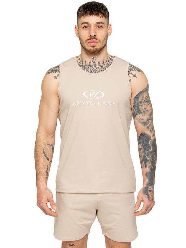 The Enzo Men's Gym Vest & Shorts Tracksuit is designed for ultimate comfort and performance. The regular-fit sleeveless vest provides a relaxed yet athletic look, with stretch material and Lycra fabric ensuring flexibility and freedom of movement. The matching gym shorts feature a regular fit and an elasticated waistband for a secure and comfortable fit. The bold Enzo Jeans branding on the chest and thigh adds a stylish, sporty touch.