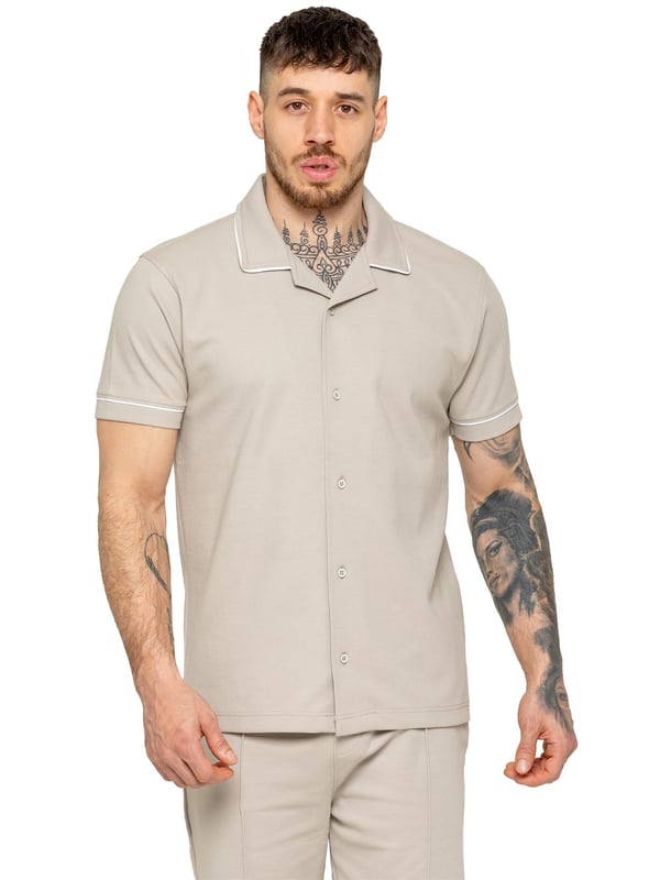 The Enzo Men's Piping Shirt & Shorts Tracksuit offers a stylish and comfortable look. The button-up shirt features a revere collar and white piping details on the collar and sleeves for a refined touch. Made from stretch fabric, it provides flexibility and a sleek fit. Paired with matching stretch shorts, this set ensures comfort and functionality with an elastic waistband, adjustable drawstring, and multiple pockets. Perfect for casual outings or lounging in style. (650&619)
