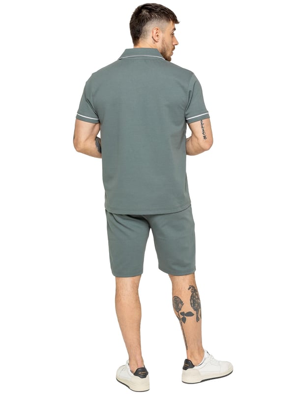 The Enzo Men's Piping Shirt & Shorts Tracksuit offers a stylish and comfortable look. The button-up shirt features a revere collar and white piping details on the collar and sleeves for a refined touch. Made from stretch fabric, it provides flexibility and a sleek fit. Paired with matching stretch shorts, this set ensures comfort and functionality with an elastic waistband, adjustable drawstring, and multiple pockets. Perfect for casual outings or lounging in style. (650&619)