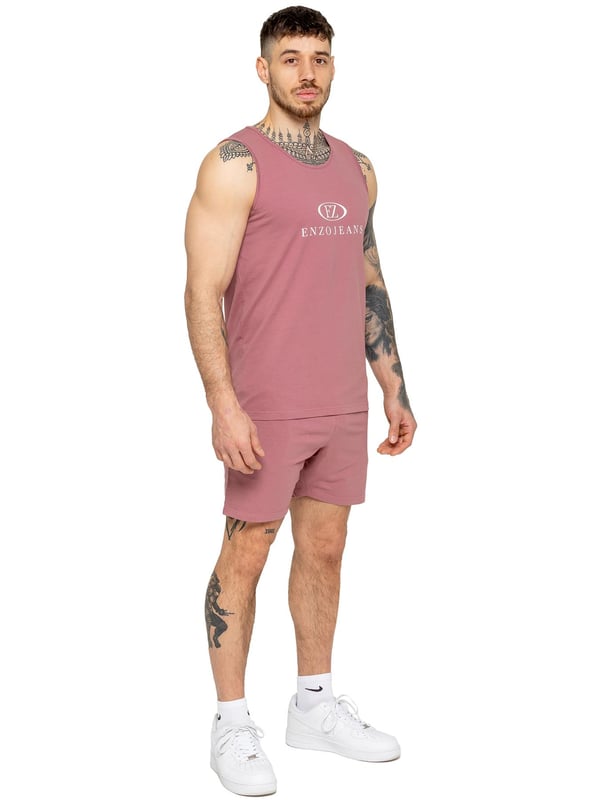The Enzo Men's Gym Vest & Shorts Tracksuit is designed for ultimate comfort and performance. The regular-fit sleeveless vest provides a relaxed yet athletic look, with stretch material and Lycra fabric ensuring flexibility and freedom of movement. The matching gym shorts feature a regular fit and an elasticated waistband for a secure and comfortable fit. The bold Enzo Jeans branding on the chest and thigh adds a stylish, sporty touch.