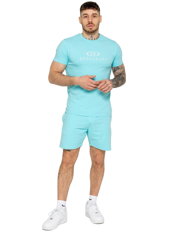 The Enzo Men's Gym Tracksuit is designed for both performance and style. The slim-fit T-shirt contours to the body for a sleek, athletic look, while the ribbed crew neck adds durability. The stretch material with Lycra fabric ensures maximum flexibility and comfort. The matching gym shorts feature a regular fit for ease of movement, with an elasticated waistband for a secure fit. The bold Enzo Jeans branding on both pieces adds a sporty edge.