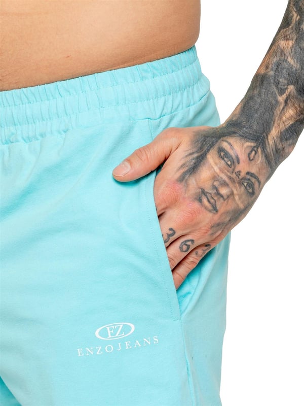 The Enzo Men's Gym Tracksuit is designed for both performance and style. The slim-fit T-shirt contours to the body for a sleek, athletic look, while the ribbed crew neck adds durability. The stretch material with Lycra fabric ensures maximum flexibility and comfort. The matching gym shorts feature a regular fit for ease of movement, with an elasticated waistband for a secure fit. The bold Enzo Jeans branding on both pieces adds a sporty edge.