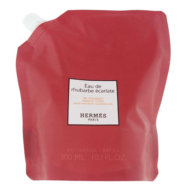 Hermes Eau De Rhubarbe Ecarlate Refill Hand And Body Cleansing Gel 300ml Hermes Eau De Rhubarbe Écarlate Refill Hand and Body Cleansing Gel (300ml) is a refreshing and revitalizing gel that gently cleanses the skin while enveloping it in a unique and vibrant fragrance. The top notes of rhubarb and red berries provide a crisp, fruity opening, complemented by the subtle floral essence of lantana in the heart. The fragrance settles into a clean, soft base of white musk, leaving the skin delicately scented. This eco-friendly refill option offers a luxurious cleansing experience, perfect for daily use to refresh and hydrate the skin while enjoying its fresh, fruity fragrance.