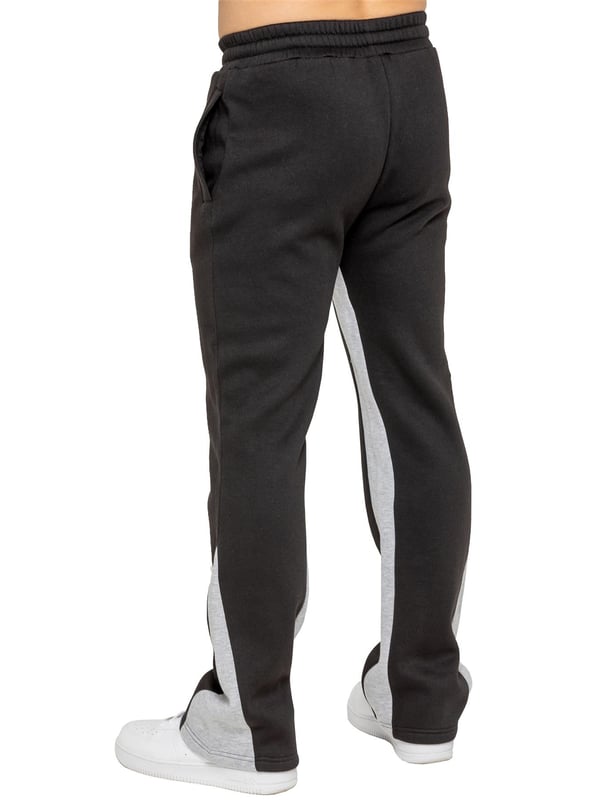 The Enzo Milano Men's Flared Joggers offer a perfect blend of comfort and style with a relaxed fit. Designed with an elasticated waistband and adjustable drawstring, they provide a customizable fit for maximum comfort. The joggers feature a contrast inner panel for a unique, stylish touch. With two side pockets for convenience and a sleek Enzo Milano rubber print on the leg, these joggers make a bold statement while staying practical.