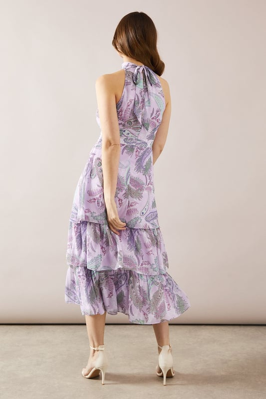 Elegant halterneck design for a sophisticated look
        Tiered midaxi length offering graceful movement
        Alluring floral print throughout the dress
        Sleeveless style perfect for warm-weather events
        Flattering fitted bodice transitioning into a flowing skirt
    
    This stunning halterneck tiered midaxi dress from Wallis is the epitome of refined elegance. The dress features a captivating floral print that adds a touch of romance to your ensemble. Its tiered design creates beautiful movement as you walk, while the fitted bodice accentuates your silhouette before flowing into a graceful skirt. Perfect for formal occasions, this dress will make you feel confident and glamorous at weddings, races, or graduations. Style it with strappy heels and a clutch bag for a polished look. For cooler evenings, drape a lightweight shawl over your shoulders. The versatile design allows for easy transition from day to night events, ensuring you remain the picture of sophistication throughout any occasion.