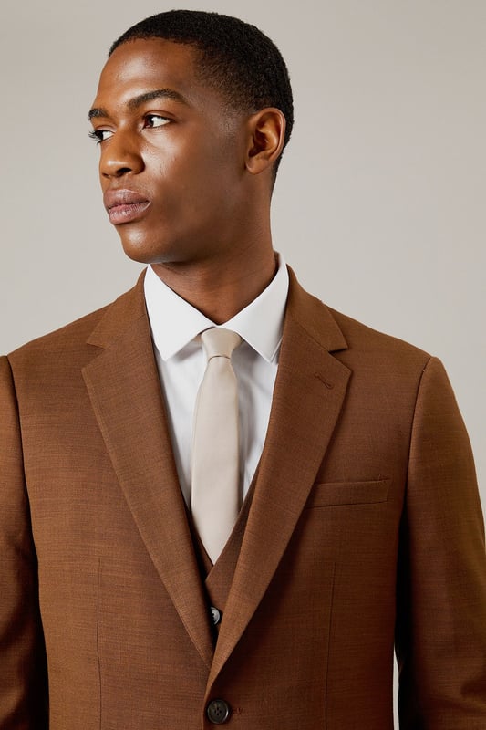 Slim fit design for a modern, tailored silhouette
        Notched lapels for a classic suit jacket appearance
        Two-button front closure for versatile styling
        Flap pockets at the waist for practicality and style
        Subtle twill texture adds depth to the fabric
    
    This Burton slim fit suit jacket is the epitome of refined style for the modern gentleman. Perfect for those who appreciate classic tailoring with a contemporary edge, this jacket offers a sleek silhouette that flatters the figure without compromising on comfort. The versatile design makes it ideal for a range of occasions, from important business meetings to sophisticated evening events. Style it with the matching trousers and waistcoat for a complete look, or pair it with dark denim and a crisp white shirt for a smart-casual ensemble. The subtle twill texture adds an interesting dimension to the fabric, ensuring you stand out for all the right reasons. Whether you're heading to the office, a wedding, or meeting friends at an upscale pub, this jacket will help you project confidence and style.