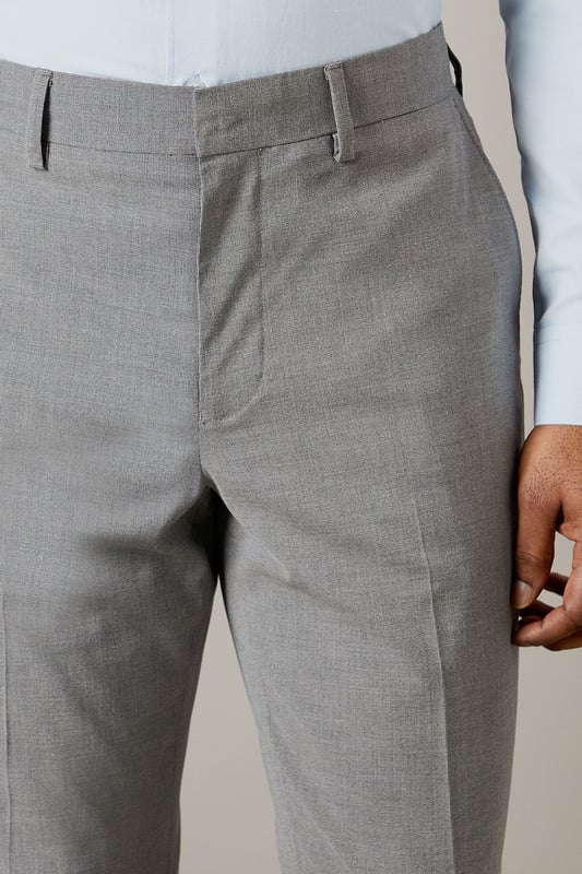 Tailored fit for a refined silhouette
        Textured fabric adds depth and interest
        Belt loops for versatile styling options
        Side pockets for practicality
        Crisp centre crease for a polished look
    
    These Burton suit trousers present a sophisticated option for the discerning gentleman. The tailored fit sculpts the silhouette while offering ease of movement, perfect for the man who values both style and comfort. The textured fabric introduces a subtle element of visual interest, setting these trousers apart from plain alternatives. Pair with the matching jacket for a complete suit, or style separately for smart-casual occasions. For a classic office look, team with a crisp white shirt and polished Oxfords. Alternatively, dress down with a fine-knit jumper and smart trainers for after-work drinks. The versatility of these trousers makes them a valuable addition to any wardrobe, suitable for everything from important business meetings to sophisticated evening events.