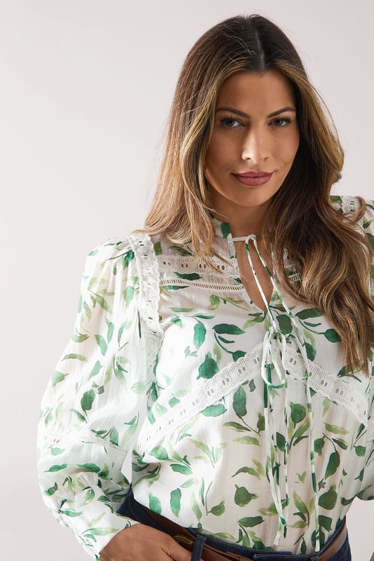 Charming floral print blouse with delicate lace inserts
        Elegant crew neckline with tie-front detail
        Long sleeves with gathered cuffs for a feminine touch
        Flattering loose fit for comfort and style
        Versatile design suitable for various daytime occasions
    
    Embrace effortless sophistication with this enchanting floral printed blouse from Wallis. The intricate lace inserts add a touch of romance, while the tie-front detail at the neckline allows for customisable styling. Perfect for those who appreciate comfort without compromising on glamour, this blouse pairs beautifully with wide-leg trousers as shown, or your favourite A-line skirt. Ideal for family gatherings, casual brunches, or a day out shopping, this versatile piece can be dressed up or down with ease. Add a statement belt and some delicate jewellery to complete your look. For a relaxed yet put-together ensemble, team with comfortable flats and a tote bag. This blouse is a wardrobe essential that will have you looking polished and feeling confident for any daytime event.