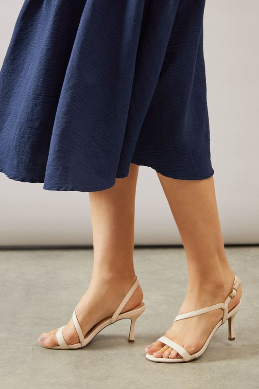 Asymmetric strappy design for a modern, eye-catching look
        High stiletto heel measuring between 7-9cm for elegant height
        Slingback strap with adjustable buckle for a secure fit
        Open-toe silhouette perfect for showcasing pedicures
        Versatile neutral hue suitable for various outfits and occasions
    
    Step into sophistication with the Maren Asymmetric High Stiletto Heel Sandal from Wallis. These stunning heels are designed to make a statement at any formal event, from weddings to races and graduations. The asymmetric strappy design adds a contemporary twist to classic elegance, whilst the high stiletto heel lends a graceful silhouette. Pair these sandals with a flowing midi dress for a chic ensemble, or team them with tailored trousers for a polished look. The neutral shade ensures versatility, allowing you to style these heels with a multitude of outfits in your wardrobe. Whether you're attending a glamorous soire or a sophisticated dinner, these sandals will keep you comfortable and stylish throughout the evening. The Maren sandal is the perfect choice for the fashion-forward woman who appreciates both comfort and glamour in her footwear.