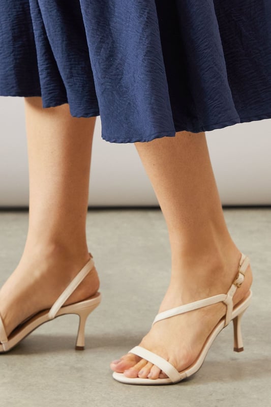 Asymmetric strappy design for a modern, eye-catching look
        High stiletto heel measuring between 7-9cm for elegant height
        Slingback strap with adjustable buckle for a secure fit
        Open-toe silhouette perfect for showcasing pedicures
        Versatile neutral hue suitable for various outfits and occasions
    
    Step into sophistication with the Maren Asymmetric High Stiletto Heel Sandal from Wallis. These stunning heels are designed to make a statement at any formal event, from weddings to races and graduations. The asymmetric strappy design adds a contemporary twist to classic elegance, whilst the high stiletto heel lends a graceful silhouette. Pair these sandals with a flowing midi dress for a chic ensemble, or team them with tailored trousers for a polished look. The neutral shade ensures versatility, allowing you to style these heels with a multitude of outfits in your wardrobe. Whether you're attending a glamorous soire or a sophisticated dinner, these sandals will keep you comfortable and stylish throughout the evening. The Maren sandal is the perfect choice for the fashion-forward woman who appreciates both comfort and glamour in her footwear.