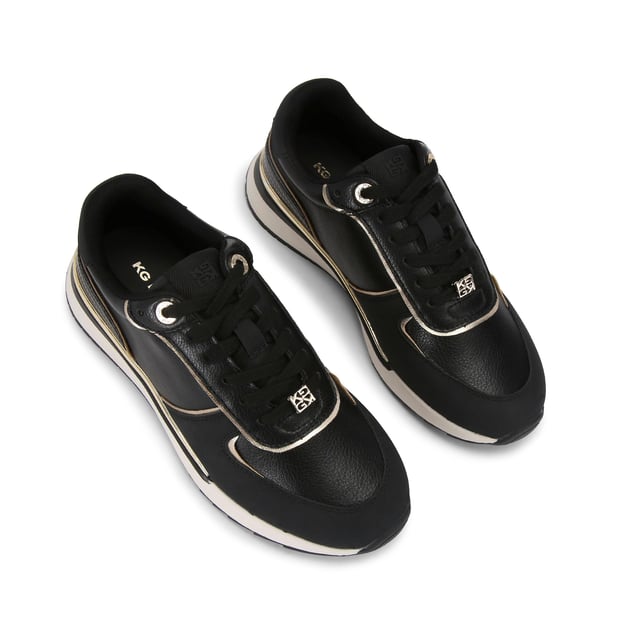 The List is a white sneaker with black and metallic gold panels across the upper. The front laces up with gold tone hardware details.