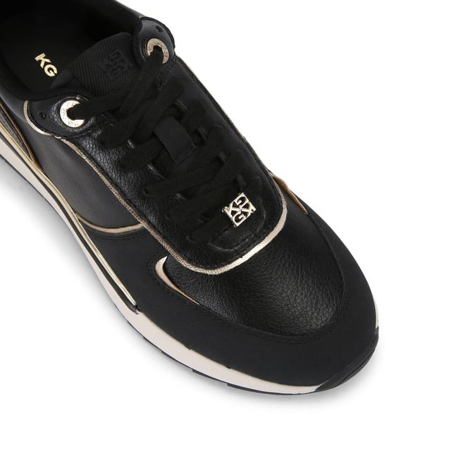 The List is a white sneaker with black and metallic gold panels across the upper. The front laces up with gold tone hardware details.