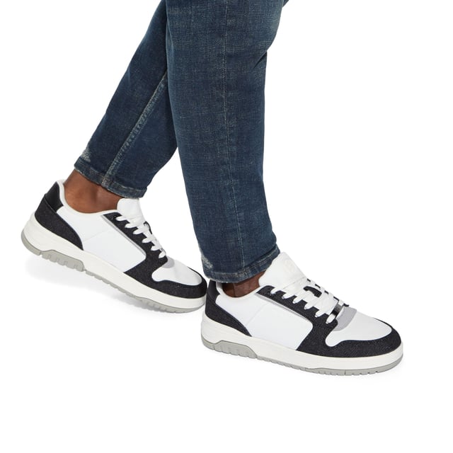This KG Kurt Geiger Ryder 2 sneaker features a white upper with black denim panel detail. The front laces up with a gunmetal branded plate. There is embossed branding on the side and tongue.