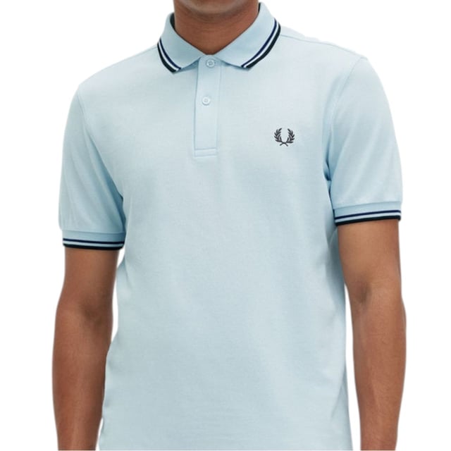 The Twin Tipped Fred Perry Polo Shirt by Fred Perry is a short sleeved polo shirt that has been made from Fred Perry's classic cotton piqué, in a contemporary adaptation of Fred's famous streamlined fit. Available in a diverse range of colourways - each with their own unique story. Featuring the signature Fred Perry wreath logo to the chest and twin tipping to the collar and cuffs.