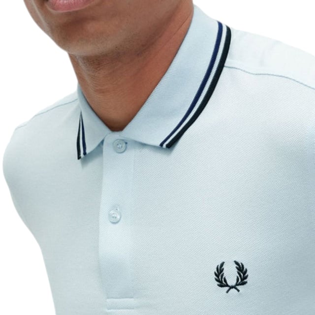 The Twin Tipped Fred Perry Polo Shirt by Fred Perry is a short sleeved polo shirt that has been made from Fred Perry's classic cotton piqué, in a contemporary adaptation of Fred's famous streamlined fit. Available in a diverse range of colourways - each with their own unique story. Featuring the signature Fred Perry wreath logo to the chest and twin tipping to the collar and cuffs.