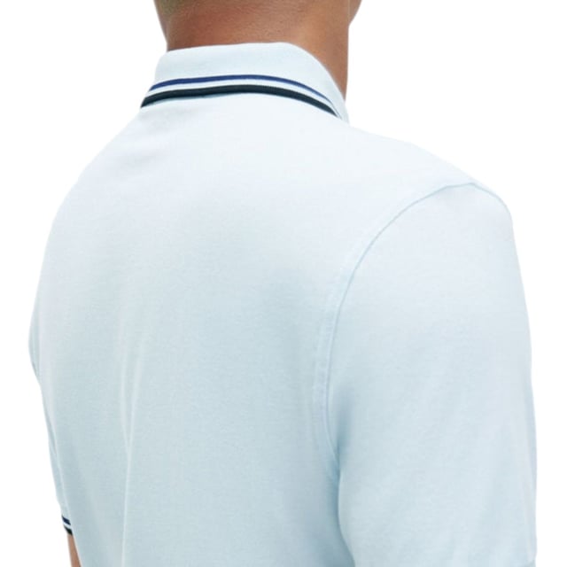 The Twin Tipped Fred Perry Polo Shirt by Fred Perry is a short sleeved polo shirt that has been made from Fred Perry's classic cotton piqué, in a contemporary adaptation of Fred's famous streamlined fit. Available in a diverse range of colourways - each with their own unique story. Featuring the signature Fred Perry wreath logo to the chest and twin tipping to the collar and cuffs.