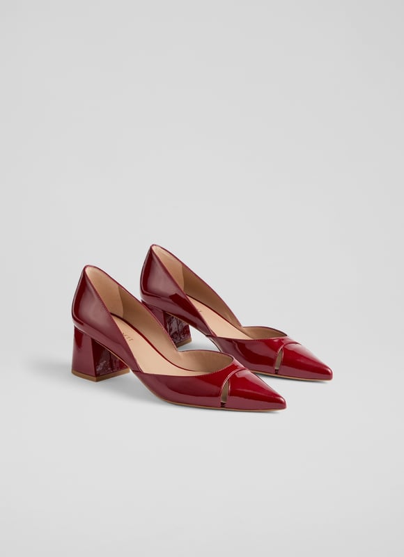 Cecile closed courts blend sophistication with modern flair. Crafted in striking red patent leather, these Spanish crafted courts feature a sleek cut-out design and a pointed toe atop a stylish block heel. Versatile for any occasion, pair them with tailored trousers for a chic office look or a flowing midi dress for an evening out. Enhance your everyday style effortlessly.