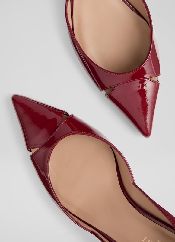 Cecile closed courts blend sophistication with modern flair. Crafted in striking red patent leather, these Spanish crafted courts feature a sleek cut-out design and a pointed toe atop a stylish block heel. Versatile for any occasion, pair them with tailored trousers for a chic office look or a flowing midi dress for an evening out. Enhance your everyday style effortlessly.