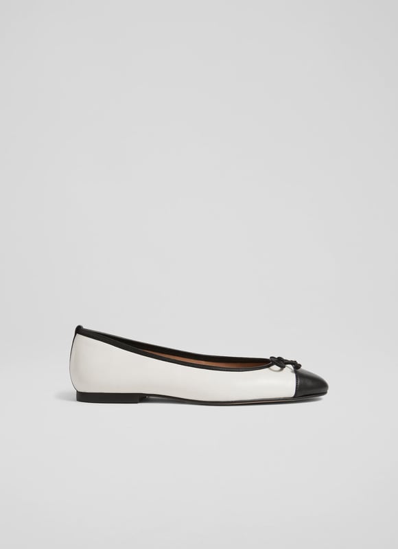 LK Bennett Kara Flats, White/Black A simple and stylish pair of flats, our Kara ballet pumps are an LKB favourite. Crafted in Spain from beautiful white nappa leather, this timeless style has a round toe with a black leather toe cap and bow detail, and a sleek silhouette. Wear them with tailored trousers or denim when you need a break from heels.