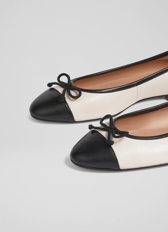 LK Bennett Kara Flats, White/Black A simple and stylish pair of flats, our Kara ballet pumps are an LKB favourite. Crafted in Spain from beautiful white nappa leather, this timeless style has a round toe with a black leather toe cap and bow detail, and a sleek silhouette. Wear them with tailored trousers or denim when you need a break from heels.