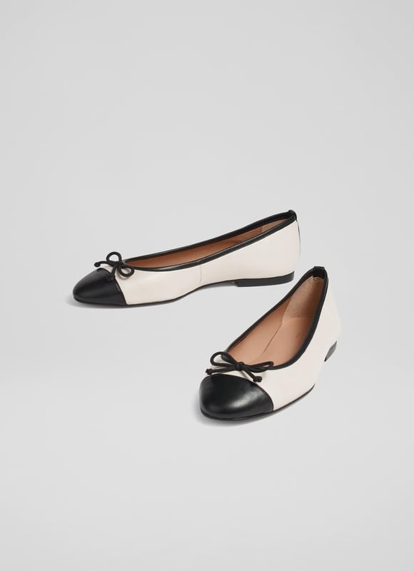 LK Bennett Kara Flats, White/Black A simple and stylish pair of flats, our Kara ballet pumps are an LKB favourite. Crafted in Spain from beautiful white nappa leather, this timeless style has a round toe with a black leather toe cap and bow detail, and a sleek silhouette. Wear them with tailored trousers or denim when you need a break from heels.