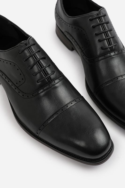 Enhance your formal footwear collection with these  Adam textured oxford lace up work dress shoes. Designed with sophistication and comfort in mind, these shoes are the perfect choice for formal occasions, business meetings, or evening events. 
Key Features: 
 Chic Design: The lace up offers a distinctive and stylish look, setting these shoes apart from conventional formal footwear. The smooth leather finish and clean lines create a polished and sophisticated appearance. 
  Durable Construction: Made with high-quality PU material, these shoes are built to last. The sturdy outsole ensures reliable wear, while the precise stitching adds durability and refinement to the overall design. 
   Comfortable Fit: Designed for all-day wear, these shoes feature a padded insole that provides excellent cushioning. The slip-resistant outsole ensures stability and comfort, making them ideal for long hours of wear. 
Specifications 
Material: Premium-quality faux leather 
Closure: Lace up. 
Outsole: Durable and slip-resistant 
Elevate your formal attire with these Michael textured oxford lace up work dress shoes. Combining style, durability, and comfort, they are an essential addition to any wardrobe. Perfect for professionals and fashion-forward individuals alike!