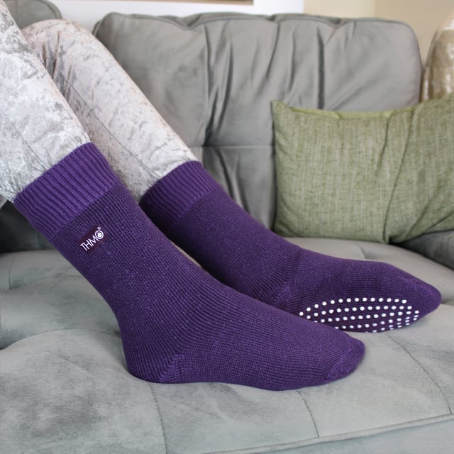 If you're looking for a slipper sock that's going to keep your little one's feet nice and cosy, look no further than THMO Kids Thermal Slipper Socks. The perfect pair to keep them warm while playing indoors. These socks have a stretchy comfort top that moulds to their leg to reduce constriction rings and tightness, which allows for regular circulation. As well as all day comfort, these socks feature a cushioned foot bed providing feet with an extra layer of support. They have been double brushed on the inside to maximise warmth by trapping warm air and keeping it close to their feet and legs. This inner brushing also softens the inside of the sock making it a great choice for keeping them warmer for longer. These anti slip grippers have been designed to prevent you from slipping on surfaces such as hard wooden floors or kitchen tiles. The dotted design on the foot of the sock is simple but effective. Perfect when they’re playing around the house. These Children’s Thermal Socks come in 4 colour options: Black, Navy, Fuchsia, Purple. They also come in 3 kids size options: 9-12 UK, 12-3 UK and 4-5.5 UK, The THMO badge is also heat transferred onto the side of the socks. These socks come in 4 different colours and are made from 93% Acrylic, 6% Polyamide, 1% Elastane. They are available in 3 Children’s sizes 9-12 UK(27-30 EUR 10-1 US), 12-3 UK (30-36 EUR, 13-4 US) and 4-5.5 UK(37-38.5 EUR, 5-6.5 US). They are machine washable at 40.