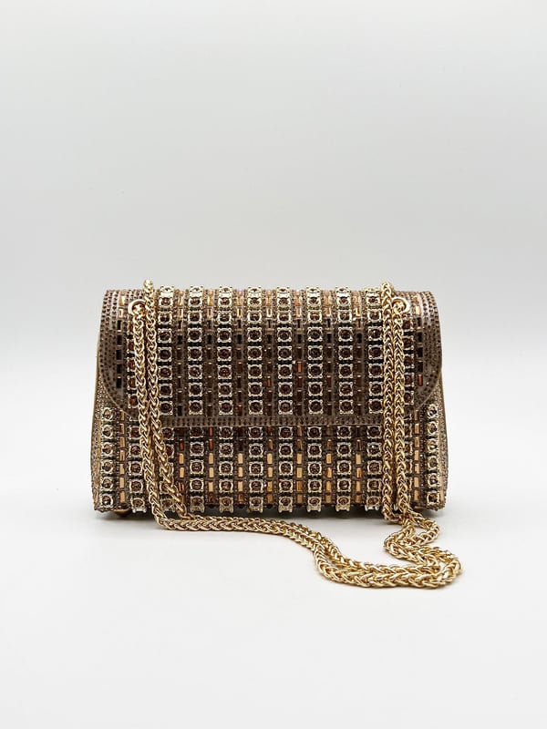 Make a bold statement with the Gold Embellished Clutch Bag by SVNX. Bursting with vibrant colors and intricate embellishments, this eye-catching piece brings a playful yet chic touch to any outfit. Carry it as a standout double chain shoulder bag or use the chain strap for crossbody. Perfect for adding flair to your look, this bag is a celebration of style and color.
Colour: Gold
Material: Rhinestone, ABS, Polyester, Metal
Care: Spot Clean Only
SKU: HB331924
Size: L:21 H:14cm W:5.5cm