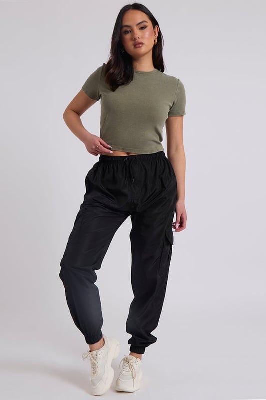 Model is 5'6 and wears a size S.Pockets. Drawstring waist band. Cuff hem. Introducing our Parachute Cargo Trouser, a versatile and stylish addition to your wardrobe that effortlessly combines functionality with fashion-forward design. Crafted with attention to detail and quality, this cargo is perfect for those who seek comfort without compromising on style.