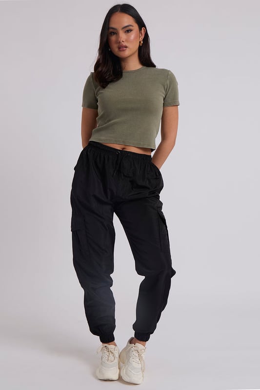 Model is 5'6 and wears a size S.Pockets. Drawstring waist band. Cuff hem. Introducing our Parachute Cargo Trouser, a versatile and stylish addition to your wardrobe that effortlessly combines functionality with fashion-forward design. Crafted with attention to detail and quality, this cargo is perfect for those who seek comfort without compromising on style.