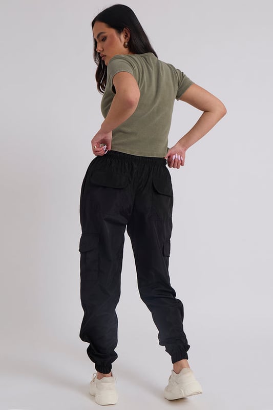 Model is 5'6 and wears a size S.Pockets. Drawstring waist band. Cuff hem. Introducing our Parachute Cargo Trouser, a versatile and stylish addition to your wardrobe that effortlessly combines functionality with fashion-forward design. Crafted with attention to detail and quality, this cargo is perfect for those who seek comfort without compromising on style.